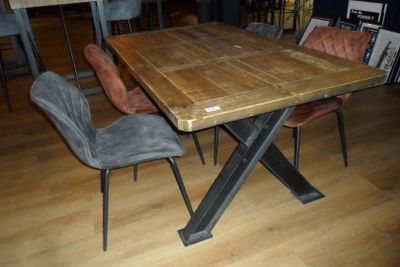 a wooden table with chairs around it on a hard wood floor