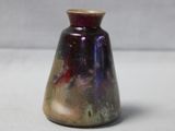 a small vase that is sitting on a table