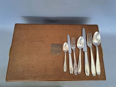 a box with silverware on it and a knife, fork, spoon, and spoon rest on it