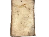 an old book that is sitting on a white surface