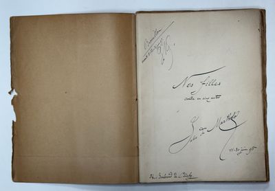 an open book with writing on it sitting on top of a table