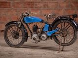 a blue motorcycle that is parked in front of a brick wall
