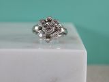 a close up of a diamond ring on a marble block