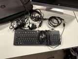 a keyboard and mouse on a desk next to a bag