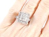 an image of a woman ' s hand with a diamond ring on it