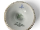 a close up of a white bowl with blue writing on it