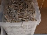 a plastic container filled with lots of screws on the floor