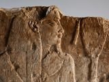 relief of a man holding a tennis racquet and a tennis racket