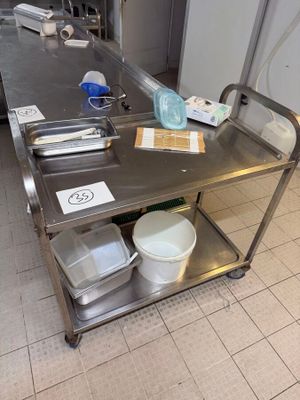 a stainless steel table with dishes on it in a kitchen