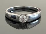 an image of a diamond ring on a reflective surface