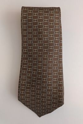 the tie is brown and white with a pattern on it