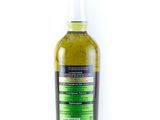 a bottle of olive oil sitting on top of a white surface