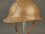 an old helmet with a lion on it is on a stand