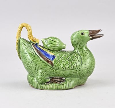 un oiseau vert au bec jaune sur un fond blanc