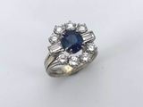 a blue sapphire and diamond ring on a white background
