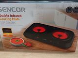 boxed picture of a black and red double infrared cooking plate on a table