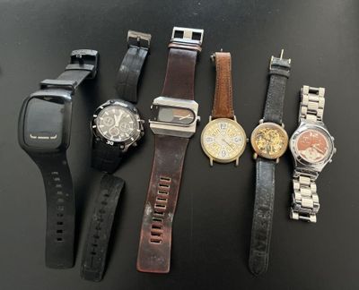 many different types of watches sitting on a table