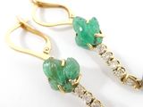pair of emerald and diamond earrings with pearls on a white surface