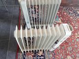 un radiateur posé à même le sol, à côté d'un tapis