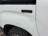 a close up of a white truck with a sticker on it ' s side