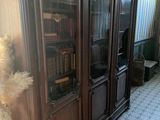 a large wooden bookcase with many books on it