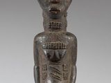 an image of a wooden statue of a man with a hat on his head