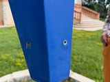 a blue pole with a hole in the middle of it