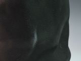 a close up of a black and brown bag with a brown handle