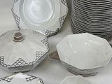 a lot of plates and bowls sitting on a table