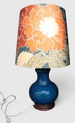 a lamp that is on a table with a lamp shade on it