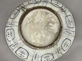 a white plate with blue and white designs on it