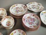 a lot of plates and cups that are sitting on a table