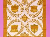 an orange and white scarf with a gold design on it