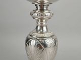 a silver goblet sitting on top of a table