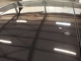 a reflection of a plane on the glass of a car