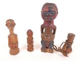 three wooden figurines are sitting next to each other on a white surface