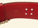 red leather belt with gold chain and studs on a white background