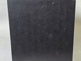 an image of a black box sitting on top of a white surface