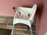 a baby high chair in the corner of a room