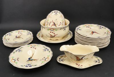 many plates and bowls with birds on them on a table