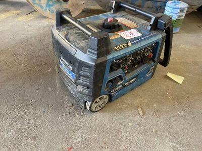 a portable generator sitting on the ground next to a skateboard