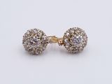 a pair of diamond earrings on a white background