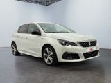 a white car is parked in a white room with a black floor