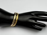 black mannequin hand with a gold ring on it ' s finger