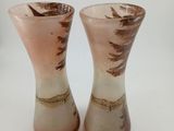 two vases that are sitting on a white surface