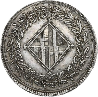 a close up of a coin with a cross on it