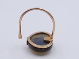 a close up of a gold ring with a blue stone in it
