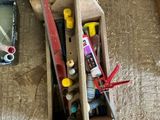 a box of tools sitting on the floor next to a pair of scissors
