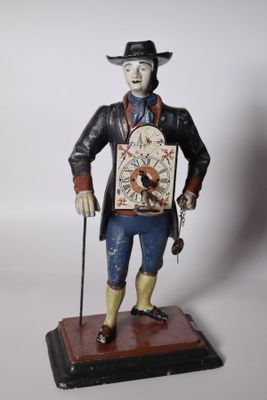 figurine of a man wearing a hat and holding a clock