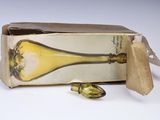 a box with a bottle and spoon inside of it